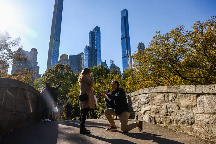 A man proposes on Gapstow Bridge during fall in Central Park in New York, United States, on October 22, 2022.
